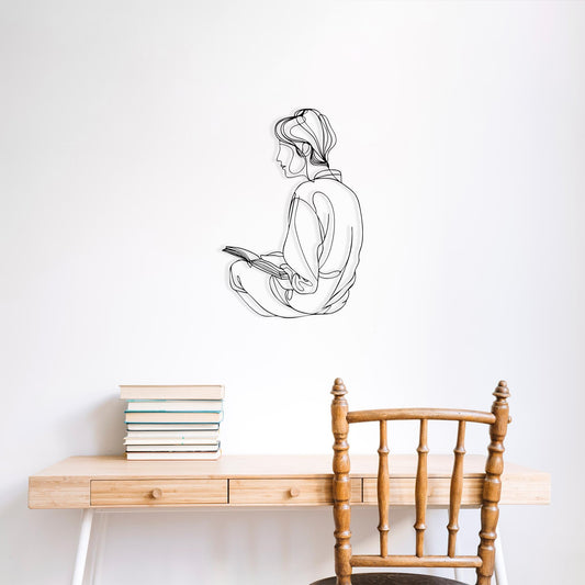 Reading Woman Metal Wall Art shown on a living room wall