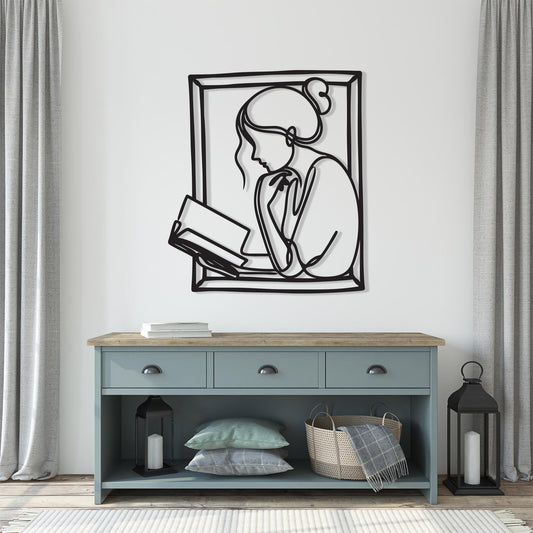 Woman Reading Metal Wall Art shown on a living room wall