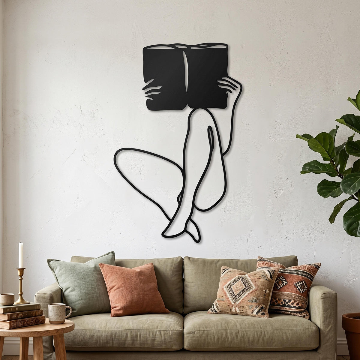 Woman Reading Metal Wall Art styled above a sofa
