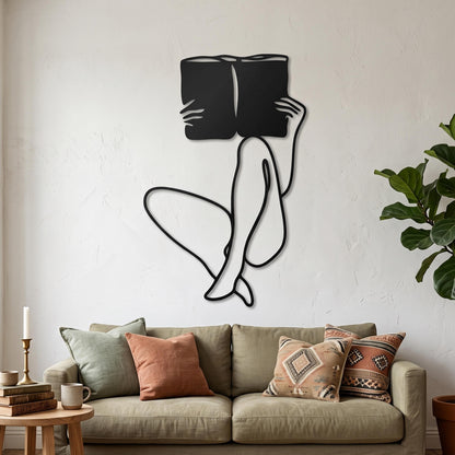 Woman Reading Metal Wall Art styled above a sofa