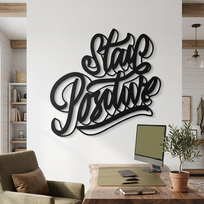 Stay Positive Metal Wall Art shown on a living room wall