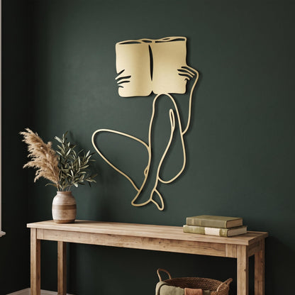 Woman Reading Metal Wall Art styled on a living room wall