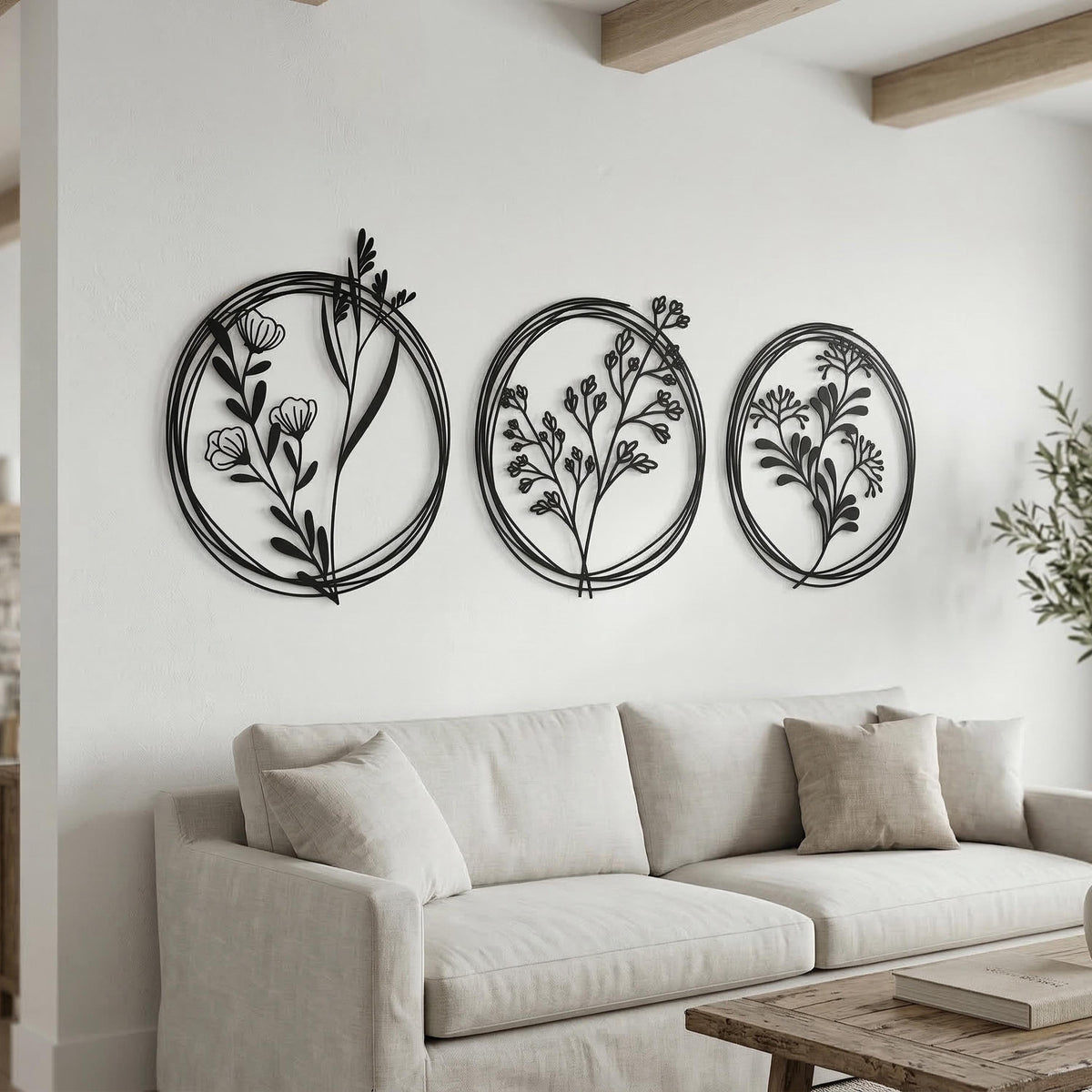 Set of 3 Metal Botanical Flower Wall Art shown on a living room wall